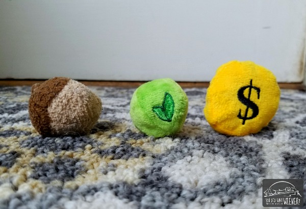 Pea from BarkShop and coin from BarkBox compared to the favorite nut toy